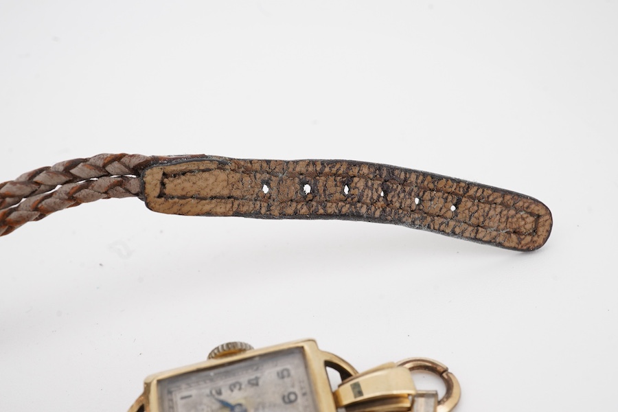 Two lady's 9ct gold manual wind wrist watches, on on fabric strap, the other on gold plated strap.